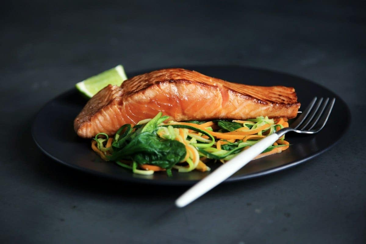 Golden caramelized pan-seared salmon bites glistening in honey garlic butter glaze with lemon slices and fresh parsley