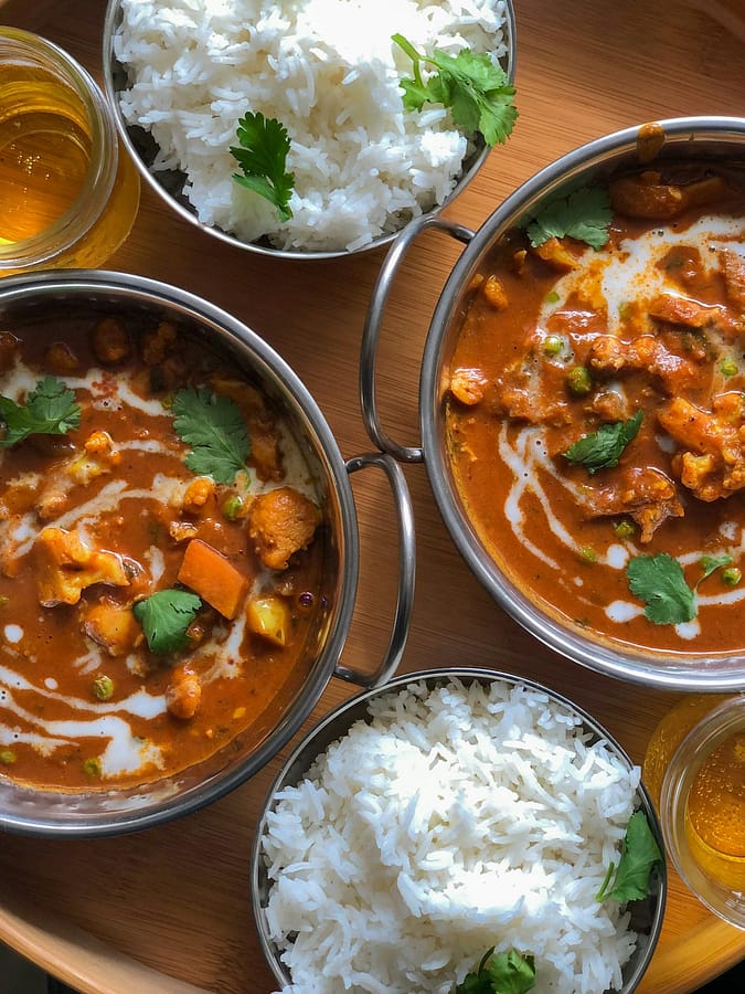 Golden Turmeric Coconut Chickpea Rice Pilaf in bowls with fresh cilantro